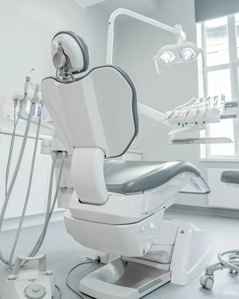 A white dental chair by a window